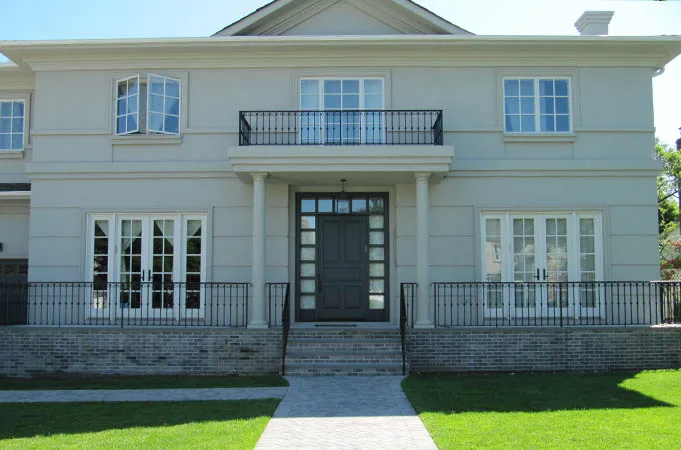 Dark entry door with sidelights and transom under a columned portico