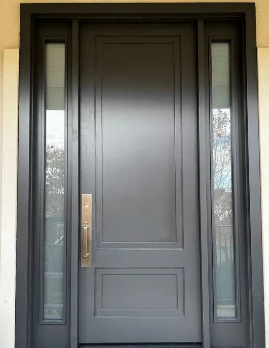 Dark gray single entry door with narrow glass sidelights
